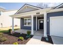 Inviting front porch with sturdy columns, leading to a modern home entrance at 5145 Cartland Dr, Indianapolis, IN 46239