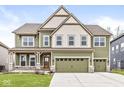 Charming two-story home with three-car garage, and well-manicured lawn on a sunny day at 5421 Landing Place Ln, Noblesville, IN 46062