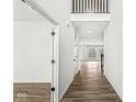 Bright hallway with wood floors, white walls, and an open view into the living area at 5421 Landing Place Ln, Noblesville, IN 46062