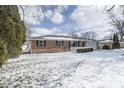 Cozy single-story brick home featuring a well-kept yard and mature trees at 5818 S Madison Ave, Anderson, IN 46013