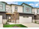 Beautiful townhome featuring modern architecture, a two-car garage, and a well-maintained front lawn at 5874 Harbour Town Dr, Noblesville, IN 46062