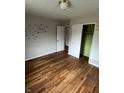 A bedroom with hardwood floors, closet and a butterfly decoration on the wall at 6533 Parker Ln, Indianapolis, IN 46220