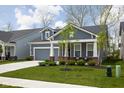 A beautiful single-story home with an attached garage, small porch area, and vibrant green lawn at 7188 Covington St, Lebanon, IN 46052