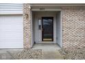 A covered entryway with a brick facade and a decorative front door enhances curb appeal at 8091 Crumwell Dr, Avon, IN 46123