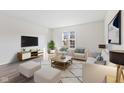 Bright living room featuring modern furniture, a large window, and stylish decor creating a cozy atmosphere at 8305 Warbler Way, Indianapolis, IN 46256