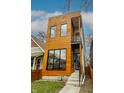 A contemporary home with light wood siding, a balcony, and black-framed windows at 924 Prospect St, Indianapolis, IN 46203