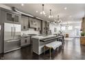 An open-concept kitchen featuring gray cabinets, a kitchen island, and stainless steel appliances at 924 Prospect St, Indianapolis, IN 46203