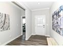 Bright foyer with hardwood floors, white trim, and an open view to the exercise room at 9716 Holborn Ave, McCordsville, IN 46055