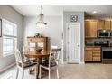 Cozy dining area with a wooden table, chandelier, and adjacent kitchen at 10246 Eller Creek Dr, Fishers, IN 46038