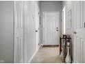 Clean, bright hallway with multiple doors, neutral paint, and a decorative side table at 10246 Eller Creek Dr, Fishers, IN 46038