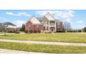 Charming two-story home with a well-manicured lawn and mature landscaping at 1032 Westview Point Dr, Columbus, IN 47201