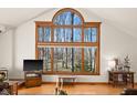 Bright living room featuring a large window with a scenic view and hardwood floors at 1086 Pebble Brook Dr, Noblesville, IN 46062