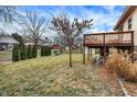 A spacious backyard featuring a manicured lawn and a charming wooden deck at 11809 Wainwright Blvd, Fishers, IN 46038