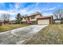 Two story home with brick and vinyl siding, attached garage, and long concrete driveway at 11809 Wainwright Blvd, Fishers, IN 46038