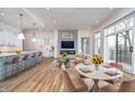 Bright, open-concept living room with modern kitchen, dining area, and fireplace with beautiful flooring throughout at 15 W Executive Dr # 104, Carmel, IN 46032