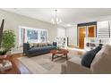 Bright living room with large bay window, hardwood floors, modern furniture, and decorative shelving at 1852 W 62Nd St, Indianapolis, IN 46260