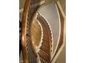 Overhead view of a winding staircase with dark wood handrail and detailed trim at 307 S Main St, Whitestown, IN 46075