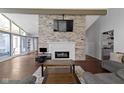 Open concept living room with fireplace, vaulted ceilings, and abundant natural light at 3645 Glencairn Ln, Indianapolis, IN 46205