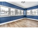 Inviting sunroom featuring new flooring and several windows for lots of sunlight at 3708 Rockville Rd, Indianapolis, IN 46222