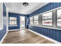 Bright sunroom featuring new flooring and natural light from several windows at 3708 Rockville Rd, Indianapolis, IN 46222