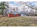 Charming single story brick home featuring a front yard, garage and gravel driveway at 4018 S State Road 75, Coatesville, IN 46121