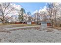 Charming single story brick home featuring a detached garage and gravel driveway at 4018 S State Road 75, Coatesville, IN 46121