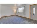 Bright living room with neutral carpet, white walls and a large window providing ample natural light at 4018 S State Road 75, Coatesville, IN 46121