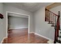 A foyer featuring hardwood floors, a staircase, and a view into the living room at 49 N Tremont St, Indianapolis, IN 46222