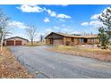 Spacious home with a detached garage and long driveway, surrounded by a large yard at 5272 N Graham Rd, Whiteland, IN 46184