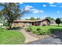 Attractive ranch home with stone accents, set back on a lawn with mature landscaping at 5272 N Graham Rd, Whiteland, IN 46184