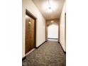 Well-lit hallway features neutral decor and arched doorway at 5347 N College Ave # 311, Indianapolis, IN 46220