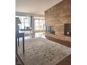 Inviting living room with a stone fireplace, hardwood floors, and an abundance of natural light from large windows at 5506 N Drexel Ave, Indianapolis, IN 46220