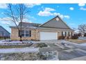 Home featuring a brick front, attached two car garage, and paved driveway at 660 Overcup St, Westfield, IN 46074