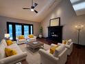Bright living room featuring hardwood floors, a black fireplace, and stylish furniture at 8150 Foxchase Cir, Indianapolis, IN 46256