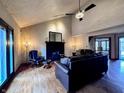 Cozy living room featuring hardwood floors, high ceilings, and a fireplace with ample natural light at 8150 Foxchase Cir, Indianapolis, IN 46256