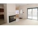 Bright living room with a tiled fireplace and sliding glass doors offering great light at 9523 Maple Way, Indianapolis, IN 46268