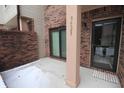 Cozy covered porch with brick detail, offering a welcoming entry to the home at 9523 Maple Way, Indianapolis, IN 46268