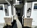 Close up front exterior view of the entrance to a townhome with decorative lanterns and the address on display at 9634 Beckett St, Avon, IN 46123