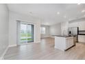 Open concept living room with sliding glass doors leading to patio and seamless flow to kitchen at 9634 Beckett St, Avon, IN 46123