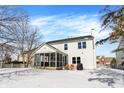 Back of house featuring a screened-in porch, patio area, and snow-covered backyard at 10010 Ashbury Cir, Fishers, IN 46037