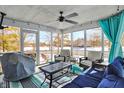 Relaxing screened-in porch with comfortable seating, ceiling fan, and bright natural light at 10010 Ashbury Cir, Fishers, IN 46037