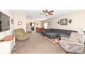 Spacious living room with comfortable seating and a ceiling fan, open to the dining area and kitchen at 1058 W Limestone Way, Fortville, IN 46040