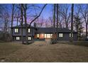 Beautiful gray home during twilight hours showcasing the inviting windows at 11035 W Lakeshore Dr, Carmel, IN 46033