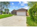 Charming home featuring a two-car garage and long driveway at 1135 Sherwood Dr, Danville, IN 46122