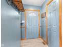 Welcoming foyer with coat rack and a painted front door at 1135 Sherwood Dr, Danville, IN 46122
