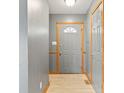 Light and bright foyer with neutral walls, wood trim, and a front door at 1135 Sherwood Dr, Danville, IN 46122