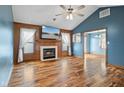 Cozy living room with hardwood floors, a fireplace, and bright windows at 1135 Sherwood Dr, Danville, IN 46122