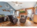 Comfortable living room featuring a fireplace, wood floors, and plush seating at 1135 Sherwood Dr, Danville, IN 46122