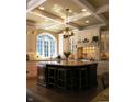 Elegant kitchen featuring a large center island, custom cabinetry, granite countertops, and a decorative coffered ceiling at 14338 Laura Vista Dr, Carmel, IN 46033