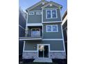 Striking new home with a balcony, sliding glass door, and stylish exterior finishes at 15403 Mystic Rock Dr, Carmel, IN 46033